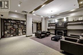 Mississauga (City Centre) condo for rent - A living room with a fireplace and a bookshelf.