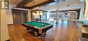 Mississauga (City Centre) condo for rent - A billiard table is in the middle of a large, empty room.