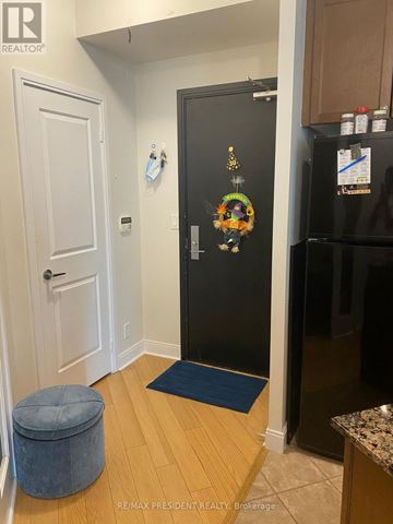 Mississauga (City Centre) condo for rent - A black refrigerator with a decorative magnet on it in a kitchen.