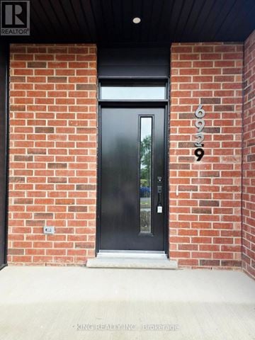 London South (South V) townhouse for rent - A black door with a glass window is set in a brick wall.