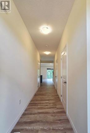 London South (South V) townhouse for rent - A long hallway with white walls and wood flooring.