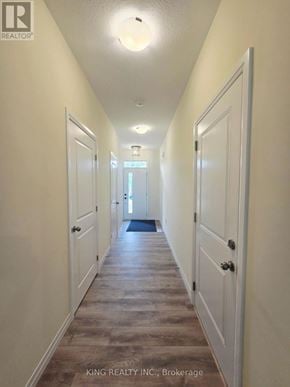London South (South V) townhouse for rent - A long hallway with doors on both sides and a rug in the middle.