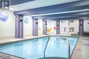 Toronto (Willowdale East) condo for rent - A large indoor swimming pool with a ladder on the right side.