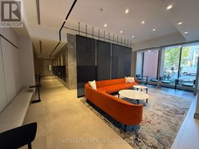 Toronto (North St. James Town) condo for rent - A modern living room with a black and orange sofa.