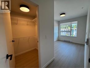 Port Moody apartment for rent - A room with a doorway leading to another room with a window.