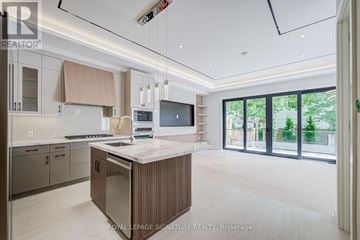 Mississauga (Lakeview) apartment for rent - A modern kitchen with a central island and a view of the backyard.