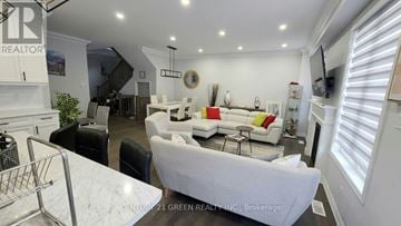 Milton (Cb Cobban) apartment for rent - A living room with a white couch and a TV on the wall.