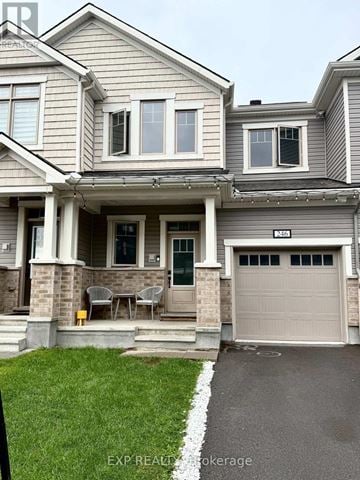 Ottawa townhouse for rent - A grey house with a white stripe on the lawn.