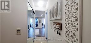 Toronto (Mimico) condo for rent - A hallway with a light switch on the wall and a doorway leading to another room.