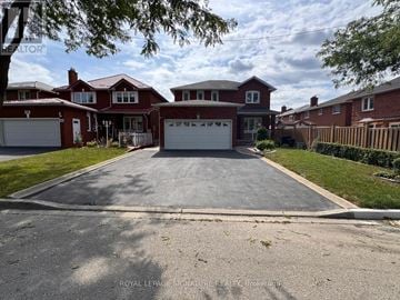 Toronto (West Humber-Clairville) apartment for rent - A large, two-story house with a red roof and white garage doors.