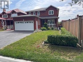 Toronto (West Humber-Clairville) apartment for rent - A red brick house with a white garage door is for sale.
