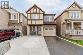 Brampton (Northwest Brampton) apartment for rent - A red SUV is parked in a driveway in front of a house.