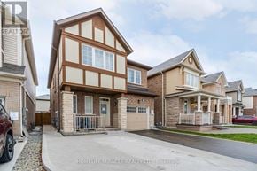 Brampton (Northwest Brampton) apartment for rent - A large house with a brown and white facade is for sale.