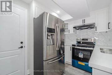 Brampton (Northwest Brampton) apartment for rent - A modern kitchen with a stainless steel refrigerator and oven.