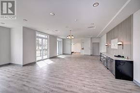 Waterloo condo for rent - A spacious room with wooden flooring and a large window.