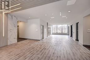 Waterloo condo for rent - A spacious office hallway with marble flooring and a modern design.