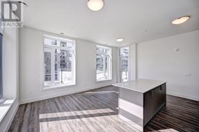 Waterloo condo for rent - A large empty room with a long counter and windows.