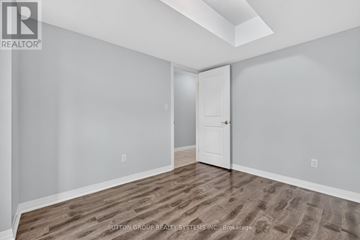 Kitchener townhouse for rent - A modern kitchen with wooden cabinets and a central island.
