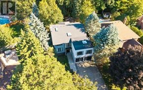 Mississauga (Erin Mills) apartment for rent - A house surrounded by trees is for sale.