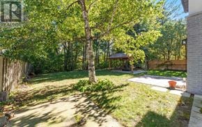 Mississauga (Erin Mills) apartment for rent - A backyard with a tree, a fence, and a small gazebo.