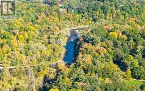 Mississauga (Erin Mills) apartment for rent - A river flows through a forest of trees with autumnal leaves.