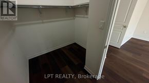 Brampton (Northwest Brampton) apartment for rent - A room with a wooden floor and white walls.