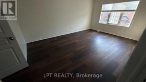 Brampton (Northwest Brampton) apartment for rent - A room with wooden flooring and a window with blinds.