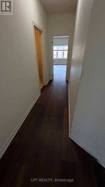 Brampton (Northwest Brampton) apartment for rent - A hallway with wood floors and white walls.
