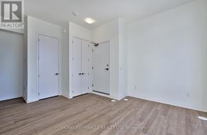 Richmond Hill townhouse for rent - A room with three white doors and wooden flooring.