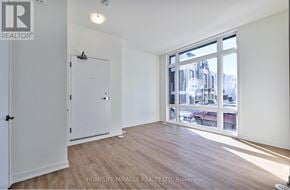 Richmond Hill townhouse for rent - A room with a white door and a large window with a view of a city.