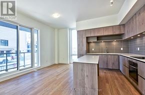 Richmond Hill townhouse for rent - A spacious kitchen with wooden floors and a modern design.