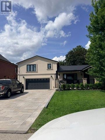 Vaughan (West Woodbridge) house for rent - A house with a garage and a car parked in front.