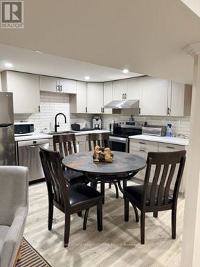 Vaughan (West Woodbridge) house for rent - A modern kitchen with a table set for four.