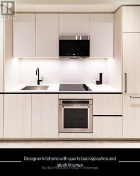 Brampton (Fletcher's Creek South) condo for rent - A modern kitchen with white cabinets and a stainless steel oven.