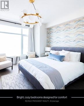 Brampton (Fletcher's Creek South) condo for rent - A bedroom with a large bed and a chandelier.