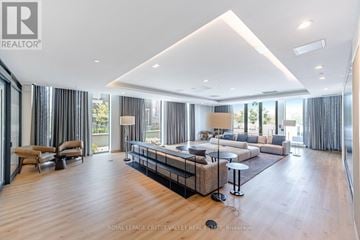 Brampton (Northwest Brampton) condo for rent - A spacious living room with a large sofa set and a television.