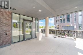 Brampton (Northwest Brampton) condo for rent - A building entrance with glass doors and a bicycle parked outside.