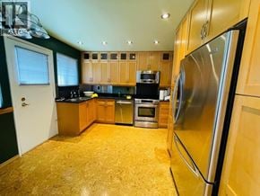 Coquitlam apartment for rent - A kitchen with a refrigerator on the right side.