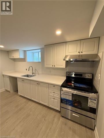 St. Catharines apartment for rent - A kitchen with white cabinets and a stainless steel oven.