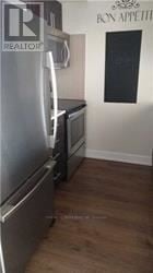 Toronto (Etobicoke West Mall) condo for rent - A kitchen with a refrigerator and a stove top oven.