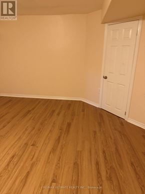 Brampton (Northwest Sandalwood Parkway) apartment for rent - A room with a white door and wooden flooring.