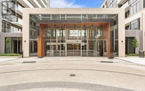 Milton (Tm Timberlea) house for rent - The entrance to a building with glass doors and a brown frame.