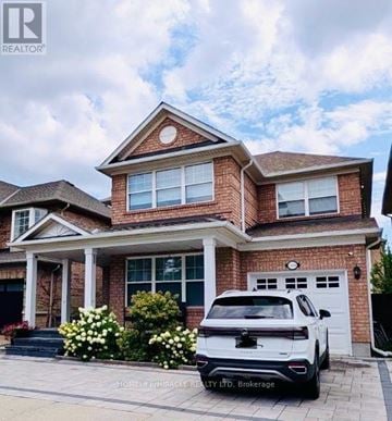 Oakville (Wt West Oak Trails) apartment for rent - A white SUV is parked in front of a brick house.