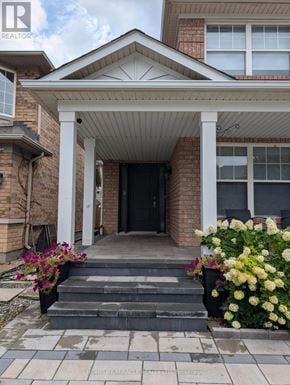 Oakville (Wt West Oak Trails) apartment for rent - A house with a front porch and steps leading to a black door.