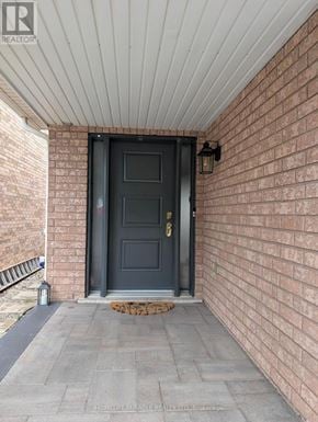 Oakville (Wt West Oak Trails) apartment for rent - A black door is on the brick wall.