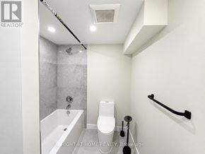 Markham (Thornhill) apartment for rent - A white bathroom with a tub, toilet and sink.