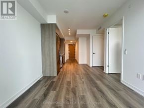 Vaughan (Concord) condo for rent - A long, narrow hallway with wood flooring and white walls.