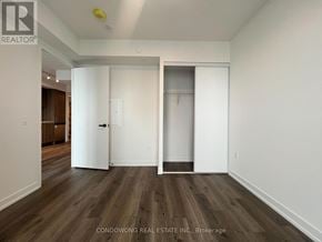 Vaughan (Concord) condo for rent - A room with wood flooring and white walls, with a door on the left and a closet on the right.