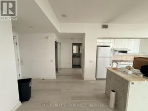 Toronto (Bayview Village) condo for rent - A kitchen area with a refrigerator, a counter, and a trash bin.