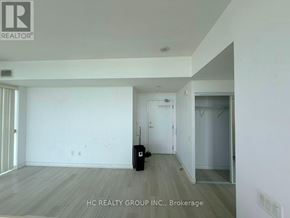 Toronto (Bayview Village) condo for rent - A room with a suitcase on the floor and a doorway leading to another room.
